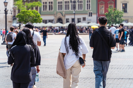 Authentic multicultural youth group on a sunny summer day on the street of an old european city, sunny summer day in the city, multiculturalism and Cultural diversity. Street style fashion