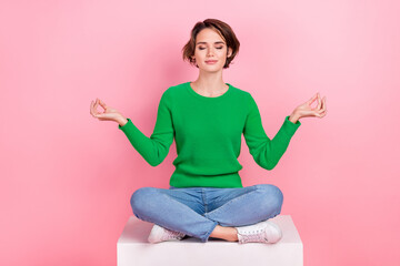 Full length photo of calm adorable girl wear trendy green clothes sitting practicing yoga relax rest isolated on pink color background