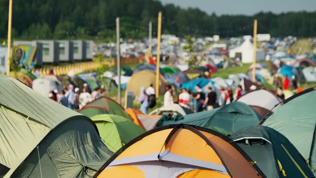 Camping area with lots of tents in countryside