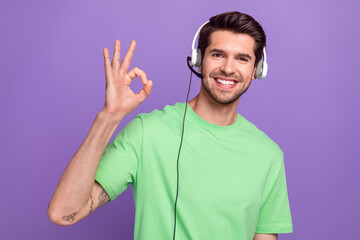 Photo of young optimistic successful call center employer show okey sign wear headset client...
