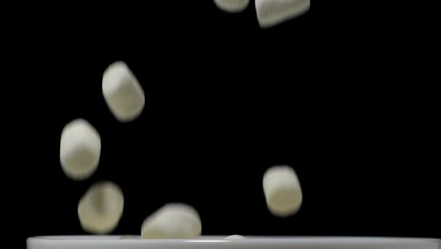 Pile of soft marshmallows falling. Sweet marshmallow falls from top to bottom.