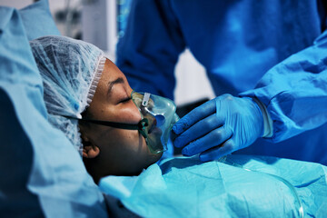 Healthcare, doctor and patient in oxygen mask for surgery, emergency care and hospital bed....