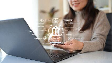 Woman using computer Laptop conducting online financial transactions through the internet. The...