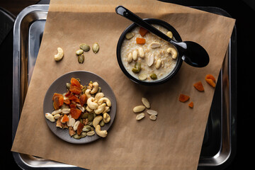Breakfast oatmeal vegan bowl with nuts top view