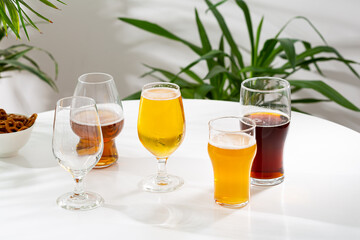 glasses with cold beer snack food and drink on light table