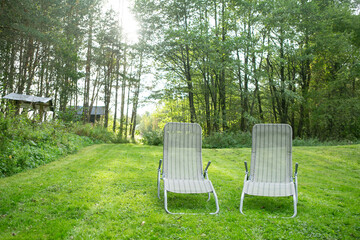 two sun loungers on the lawn in the garden