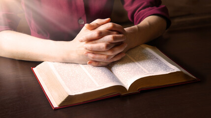 Woman's hands holding a bible