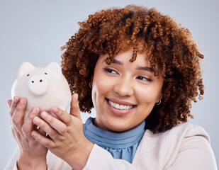 Woman with smile, piggy bank and savings in studio, finance and budget in hands with investment...
