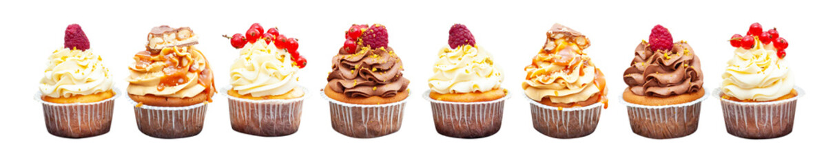 Assorted beautiful vanilla cupcakes with fresh raspberry, strawberry, red currand on wooden background