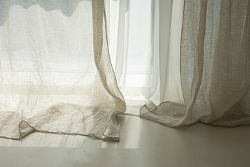 beige background with light and shadow of window curtains