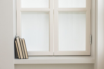 A few books by the white window