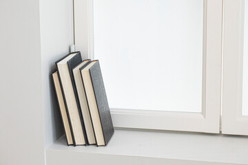 A few books by the white window