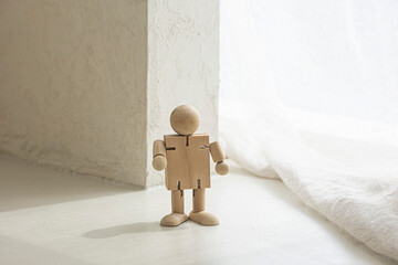 Wooden man figure, doll isolated on the ivory floor.