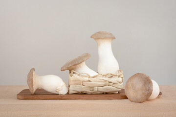 Four king trumpet mushrooms on a table and a light gray background