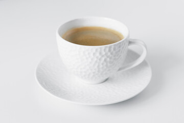 Morning black coffee in white cup on table