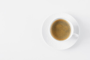 Top view of black coffee in white cup on table