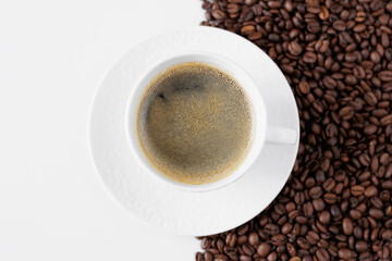 Top view of coffee mug and coffee beans on table with copy space