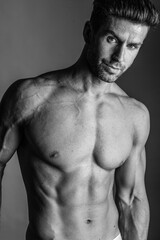 Fototapeta premium Black and white photo shoot of handsome man with perfect body.