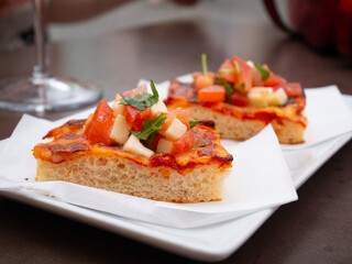 Slices of pizza for Italian aperitif at the bar Italian appetizer on the table.