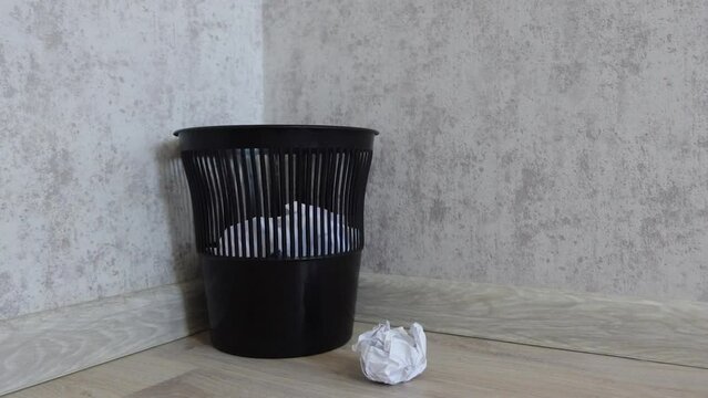 a lump of office paper flies into the trash and does not get into it. stock footage