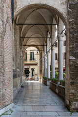 Fototapeta na wymiar columns and vaulted covered walkway at san Vito church, Treviso, Italy