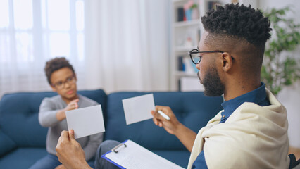 Counsellor conducting psychological testing of a child, mental health assessment