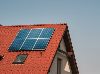 Fototapeta premium Harvesting the Sun. Sustainable Power Generation with a Solar Photovoltaic Systems on a Countryside House. Sun-produced energy. Semiconductor technology. Carbonless footprint.