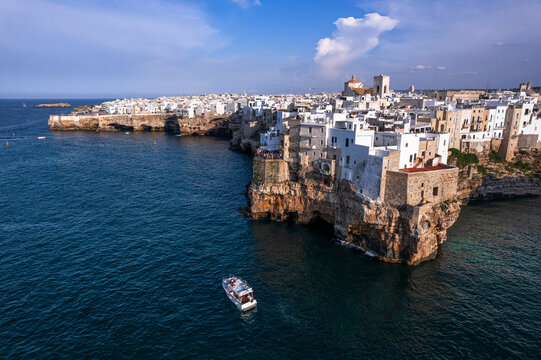 Aerial view of a boat sailing off the coast of Polignano a Mare fishing village, Bari, Apulia, Adriatic Sea Sea