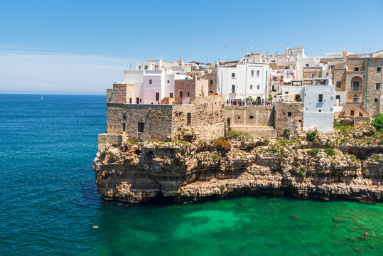 Polignano a mare, the medieval and white sea town facing the turquoise water of the Adriatic Sea, day time, Bari, Apulia Sea