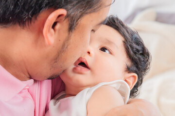 Asian newborn baby in father arm with safe and trust, Dad sing or talk with adorable daughter on...
