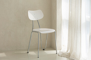Modern white chair in beige room interior
