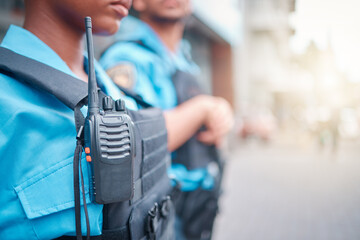 Radio, police and surveillance with a black woman officer standing outside while on patrol in the city. Walkie talkie, dispatch or communication with a female security guard in an urban town - obrazy, fototapety, plakaty