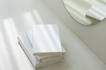 Blank hard cover book template on light floor.