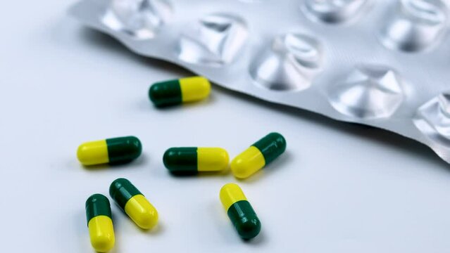 Tablets or capsule on a white background. Medicine and healthy. Close up of capsules falling down on the white background.