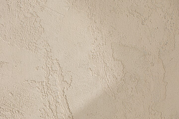 light beige painting background with light and shadow on wall.