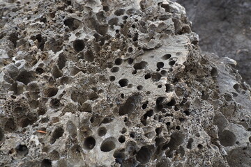 Volcanic stones. Spongy cellular loose airy porous stone material. Close-up rock near Meljine,...