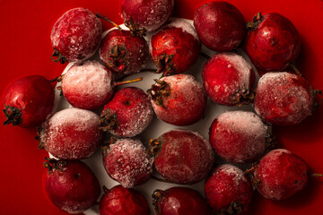 Red berries of hawthorn frosted, on a plate