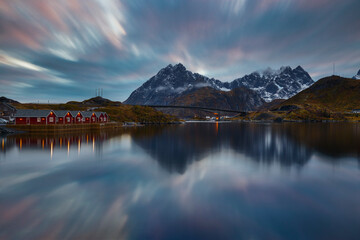 Norwegian fjord at blue hour with typical illuminated red cabins, Moskenesoya, Nordland, Lofoten, Norway, Scandinavia