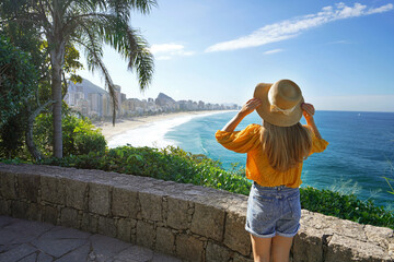 Holidays in Rio de Janeiro. Rear view of beautiful fashion girl looking at Rio de Janeiro amazing...