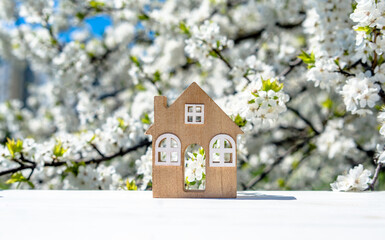The symbol of the house stands against a background of cherry blossoms
