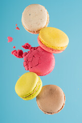 a bunch of scattered macarons on a blue background