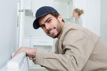 Fototapeta premium smiling technician repairing an hot-water heater