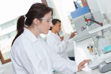 beautiful woman scientist in her lab performing chemistry experiments