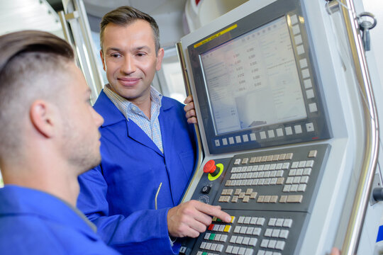 two machine operators working together