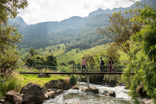 Hikers crossing bridge, Termas de Papallacta, Napo, Ecuador
