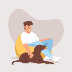 man sitting on a bag chair his dog is with him