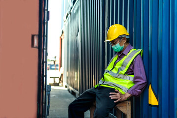 Shipping man sitting on chair feeling tired from overwork in container shipyard , Container Concept