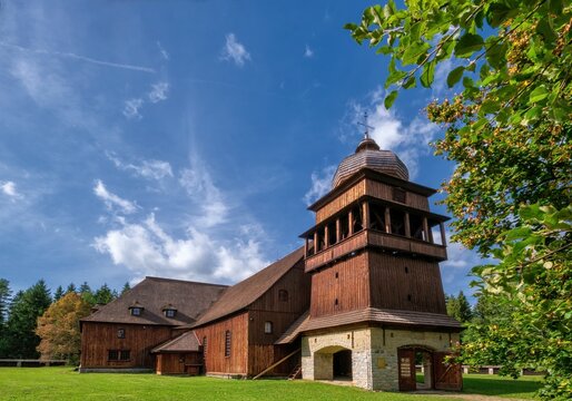 Wooden evangelical articular church of the Svaty Kriz(Holy Cross), is one of the largest wooden churches in Europe.Green meadow, blue sky white clouds, old architecture. Paludza, Svaty Kriz.
