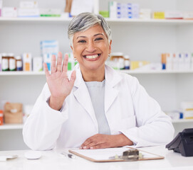 Pharmacist, portrait and hand of woman for hello at pharmacy counter for friendly service with a smile. Mature female employee in healthcare, pharmaceutical and medical industry for medicine retail