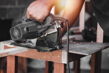 Carpenter working with equipment on wooden table, And measurement of a wooden plank